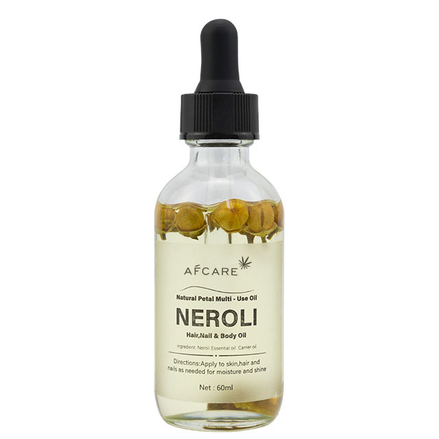 Aceite corporal de neroli con flores naturales, ideal para masajes relajantes y cuidado de la piel con aroma floral suave.