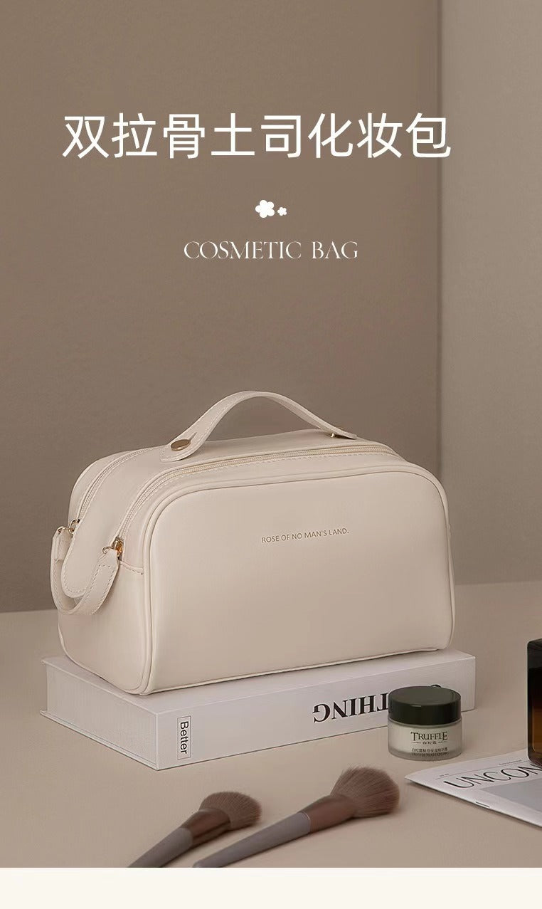 Neceser de maquillaje nuevo de PU color crema con asa superior, diseño elegante y funcional para organizar cosméticos.