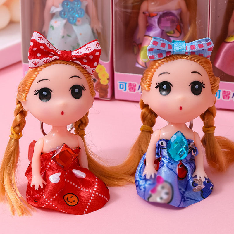 Mini muñeca coleccionable con vestido