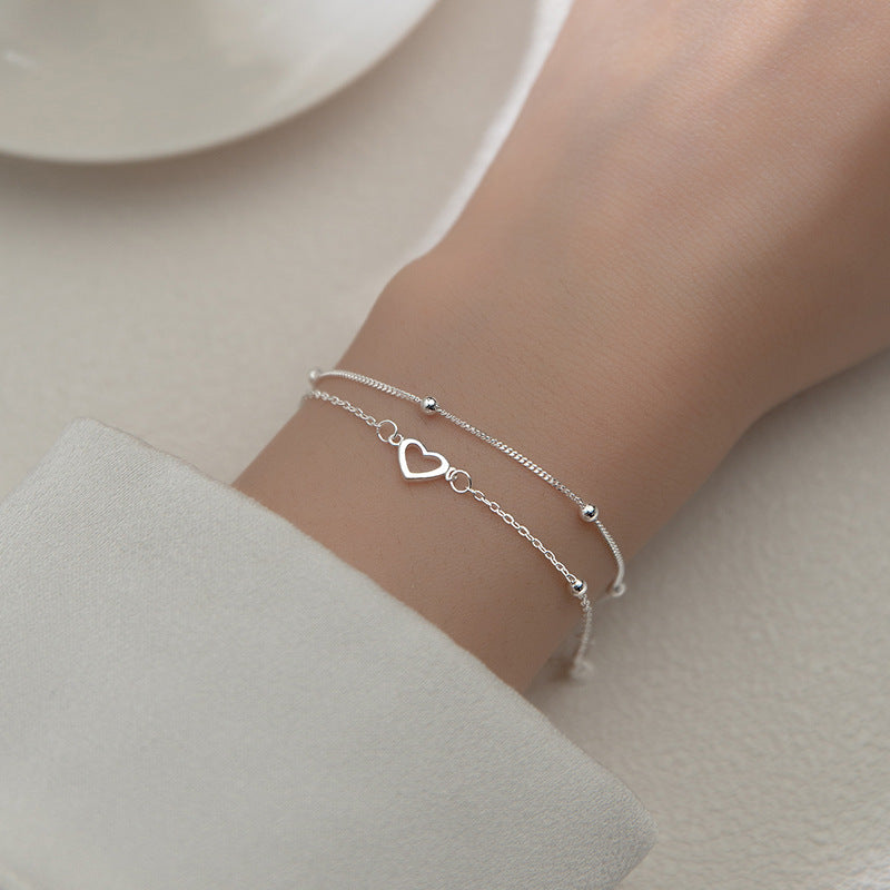 Pulsera doble cadena ajustable con pequeños corazones y esferas metálicas para mujer