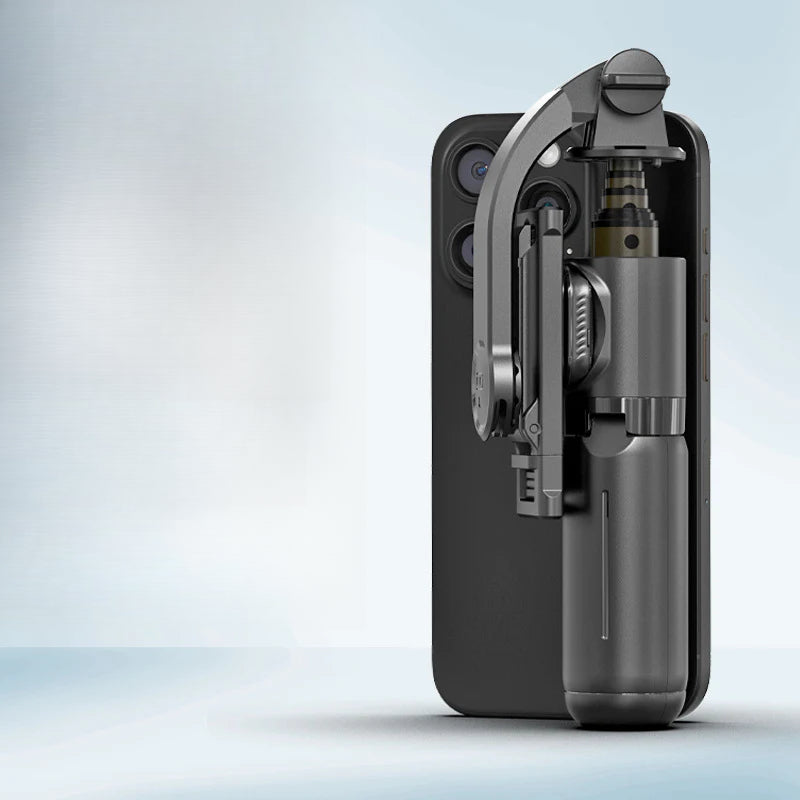 Mini Trípode Selfie Q20 con Bluetooth plegado y acoplado a un smartphone, demostrando su diseño portátil y funcional para fotografía móvil.