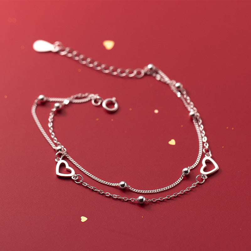 Pulsera doble cadena ajustable con pequeños corazones y esferas metálicas para mujer