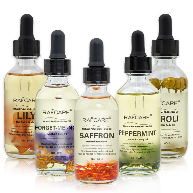 Set de aceites esenciales con pétalos naturales para cuidado corporal, incluye aromas como menta, azafrán y lirio para hidratación y brillo.