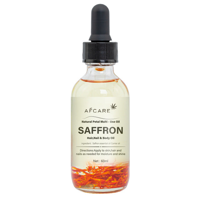 Aceite corporal de azafrán con pétalos visibles, ideal para hidratar piel, cabello y uñas con fórmula natural y aroma relajante.